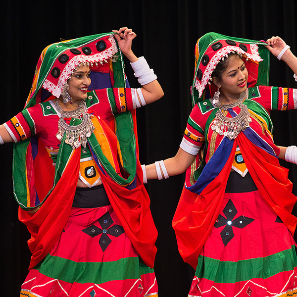 Performers wearing colorful festive clothing