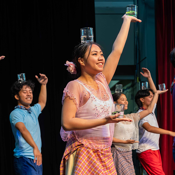 Performance of a traditional Filipino dance with glasses of water.