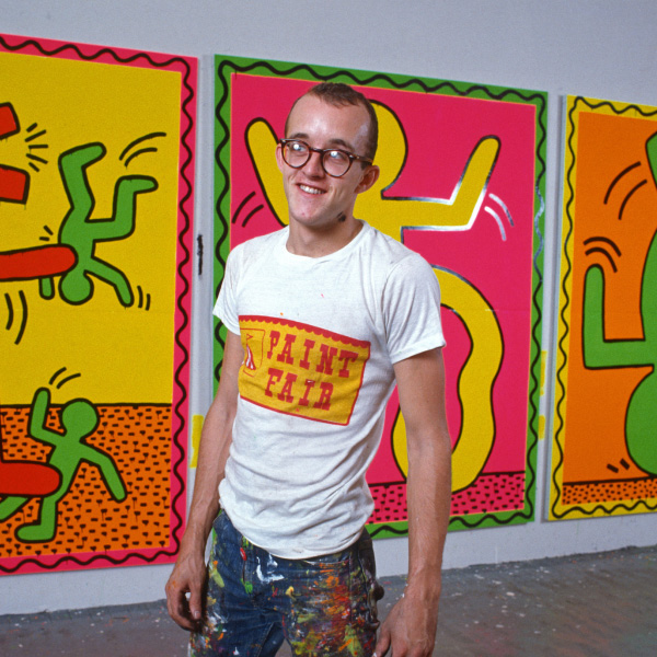 Man in front of vibrant art pieces