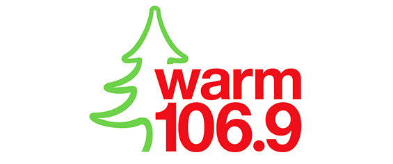 logo reads Warm 106.9 with outline of a green christmas tree 